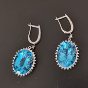 Neta - 21.00 carat oval natural blue topaz earrings with 2.50 carat natural diamonds