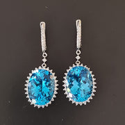 Neta - 21.00 carat oval natural blue topaz earrings with 2.50 carat natural diamonds