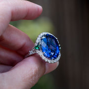 Juliana - 25.00 ct oval sapphire ring with 0.30 natural green emeralds and 1.10 carat natural diamonds